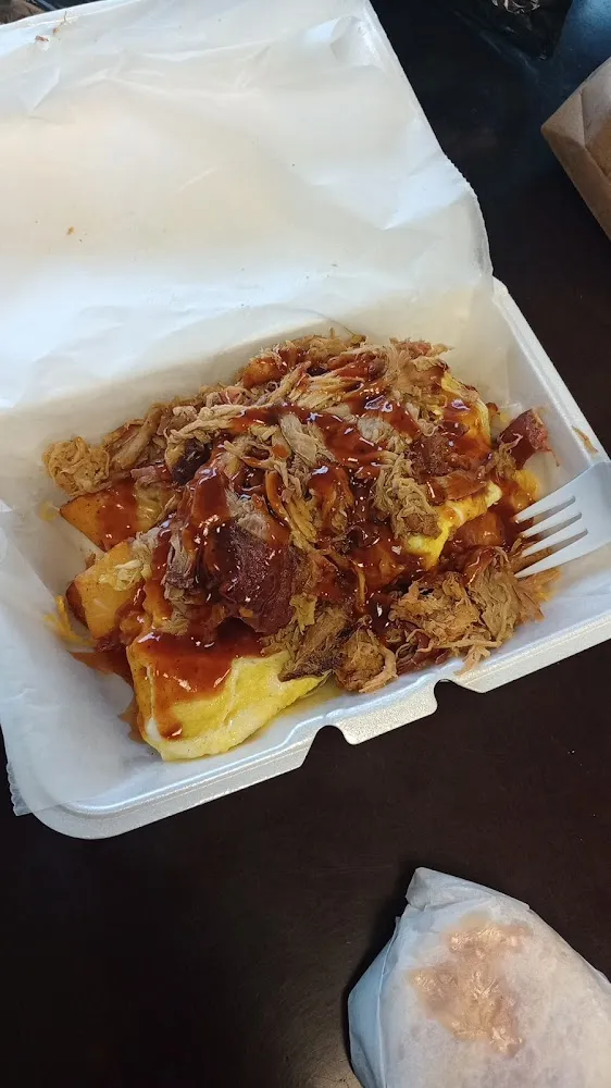 Breakfast Bowl with Pork Potatoes Eggs Cheese and BBQ Sauce